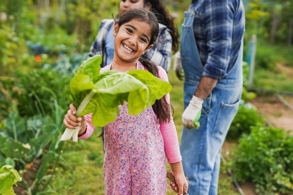 Indian father gardening with children